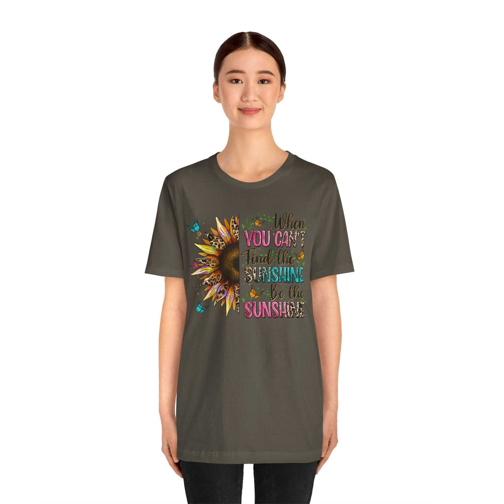 Woman wearing a dark gray Sunshine Quote Tee with colorful sunflower and inspirational text design on the front