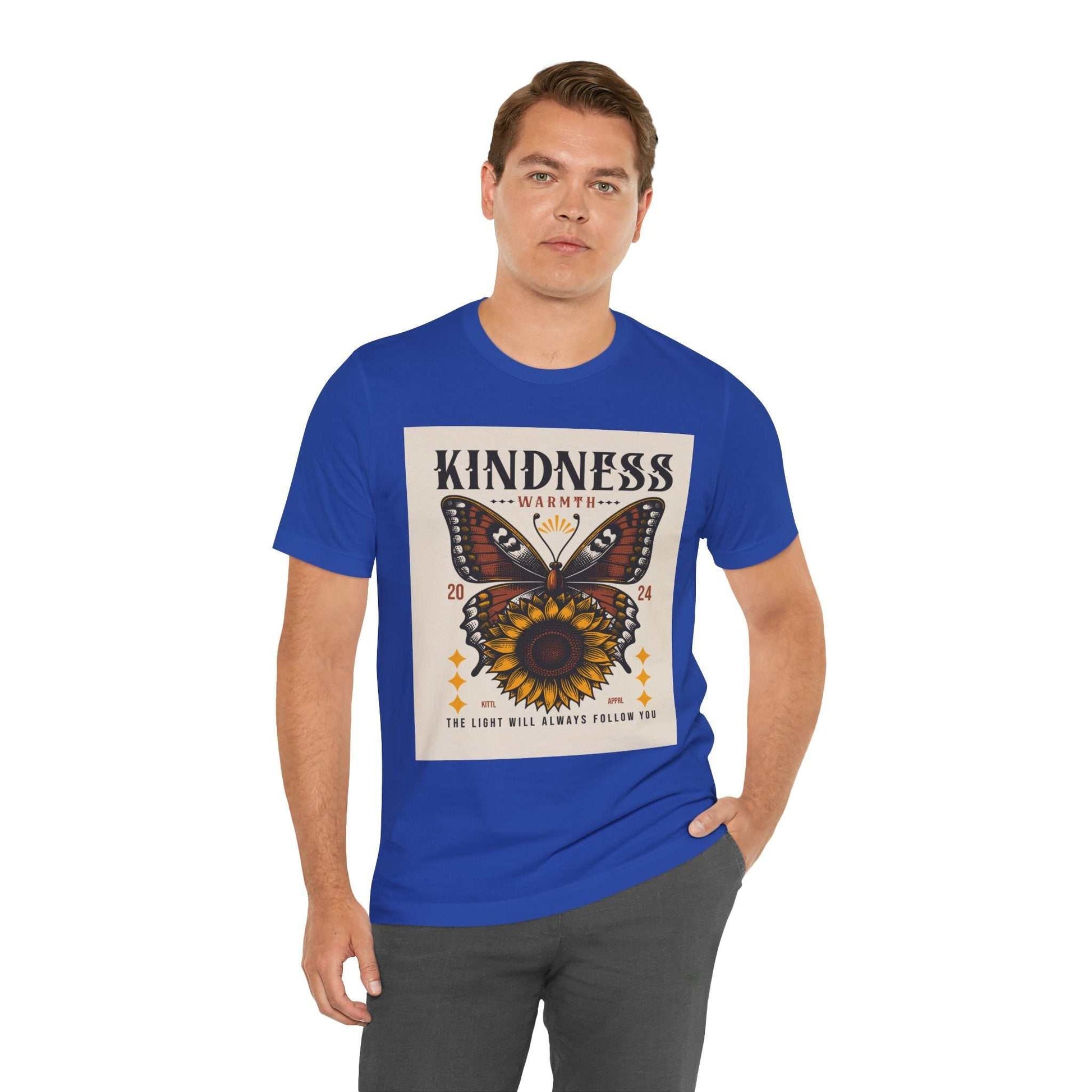 Man wearing royal blue Kindness Butterfly Tee with butterfly and sunflower graphic and kindness text on front