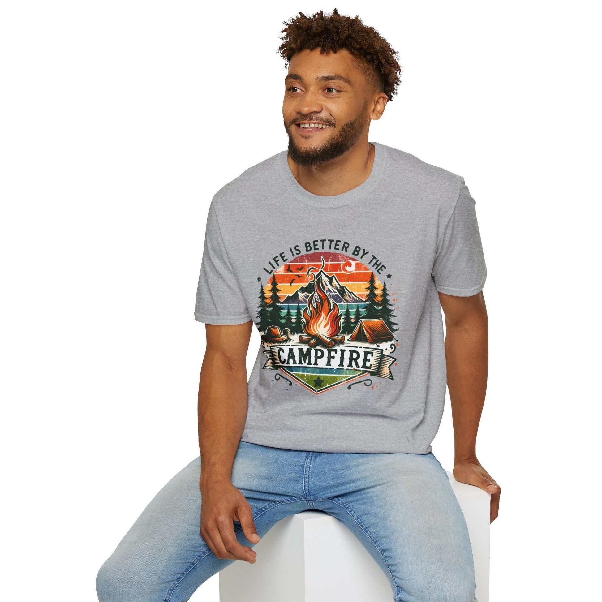 Unisex grey t-shirt with colorful campfire design and "Life is better by the campfire" text, worn by smiling man