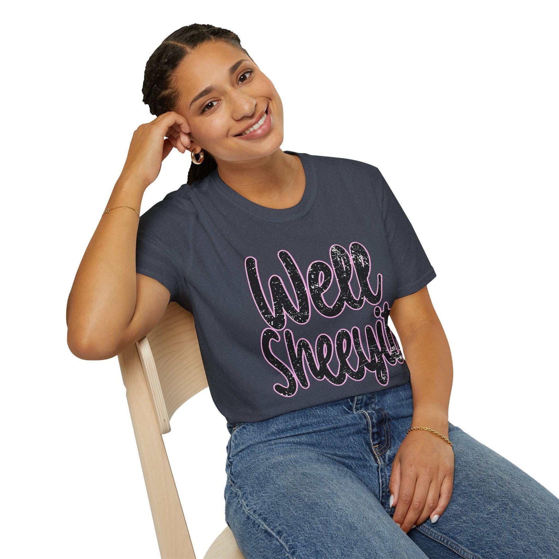 Woman wearing navy casual statement tee with "Well Sheeyit" funny quote sitting on chair