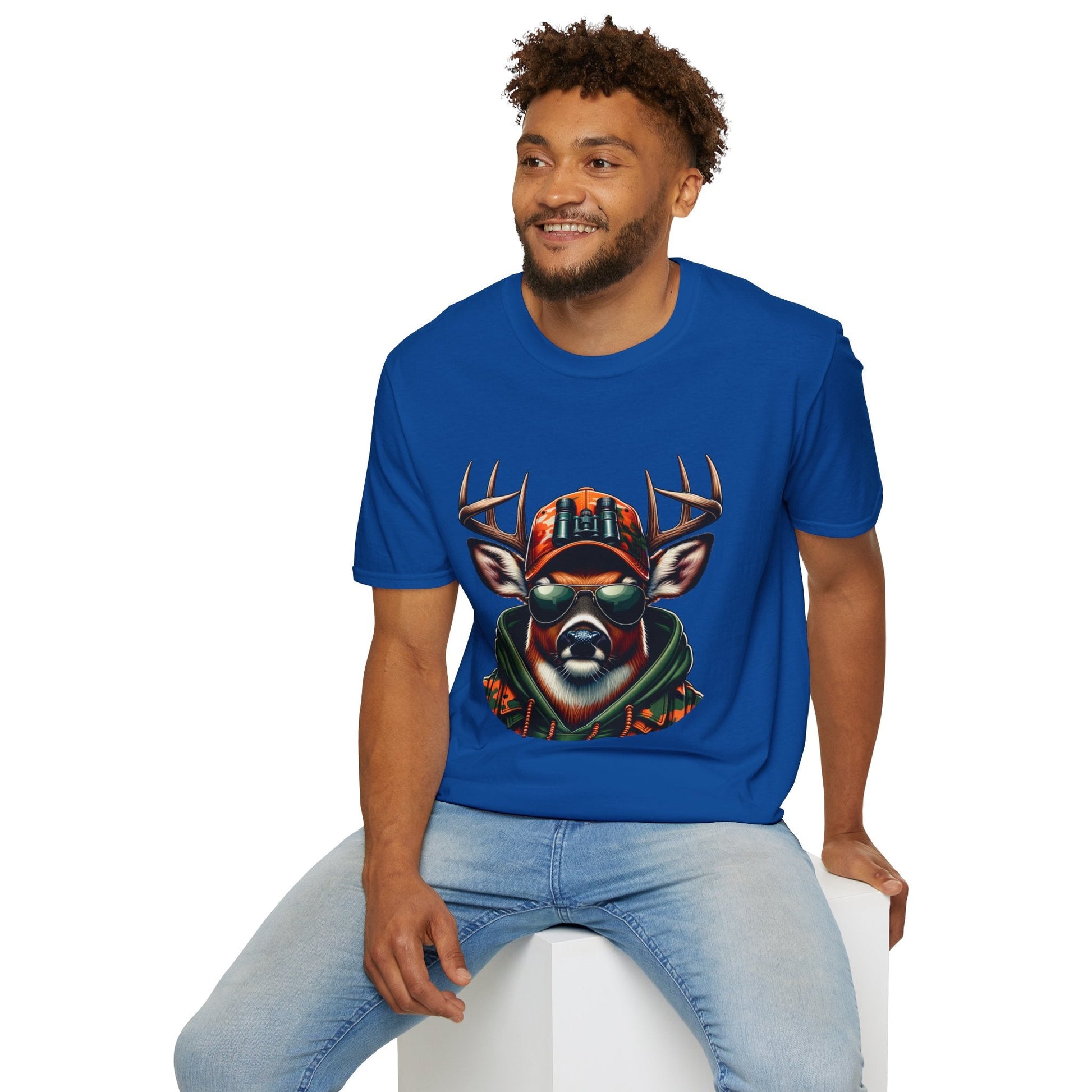 Man wearing blue Hunting Enthusiast T-Shirt with deer graphic, sitting on white block