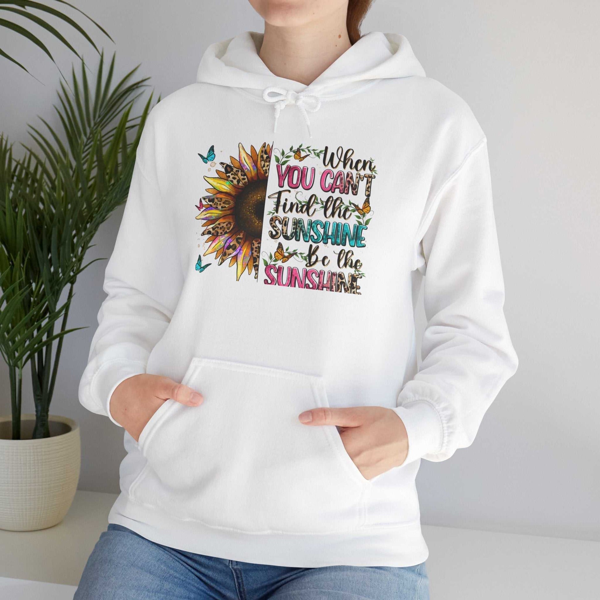 White sunflower quote hoodie with colorful inspirational text and kangaroo pocket worn by person