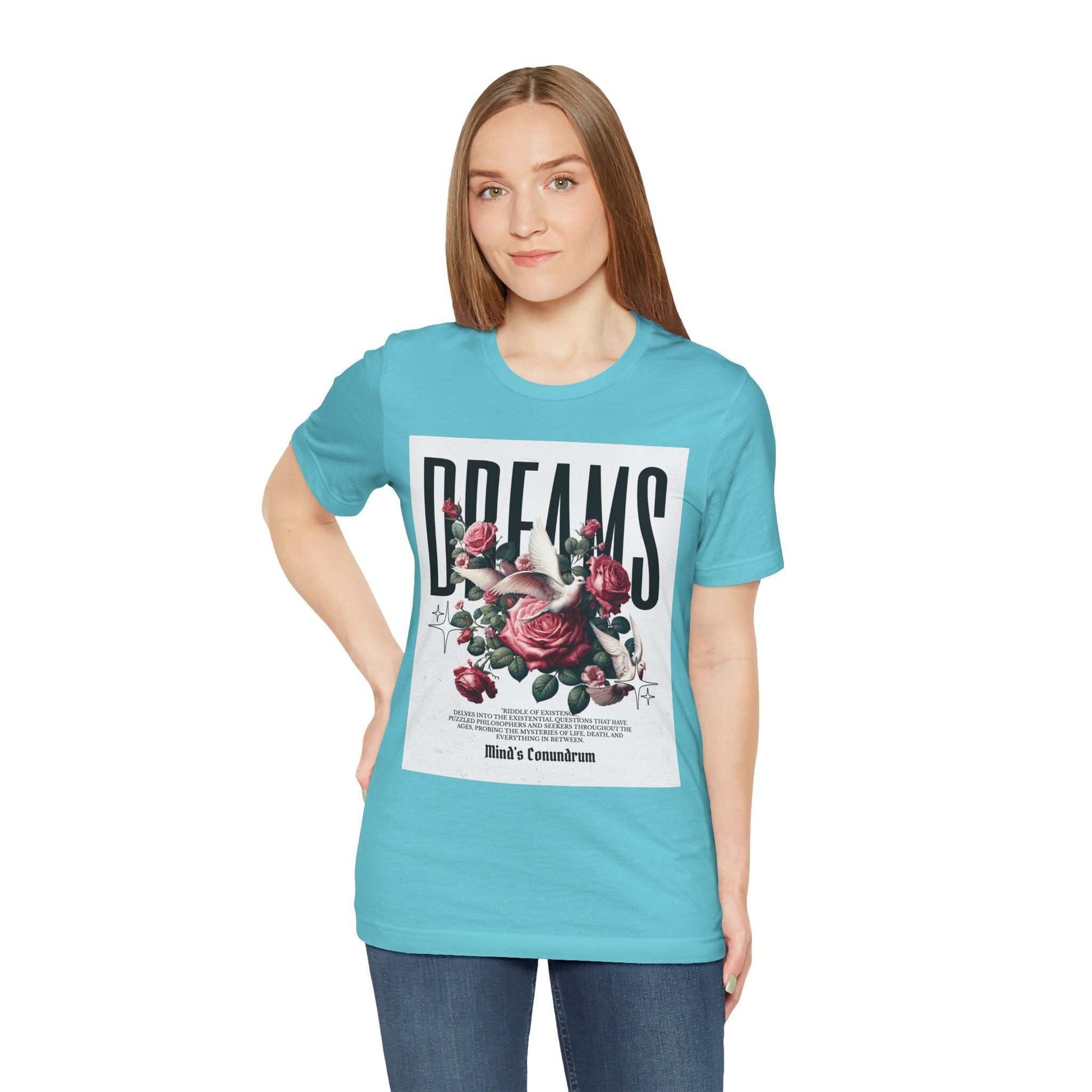 Woman wearing a light blue Dreams Floral Tee with floral and bold typography design on front