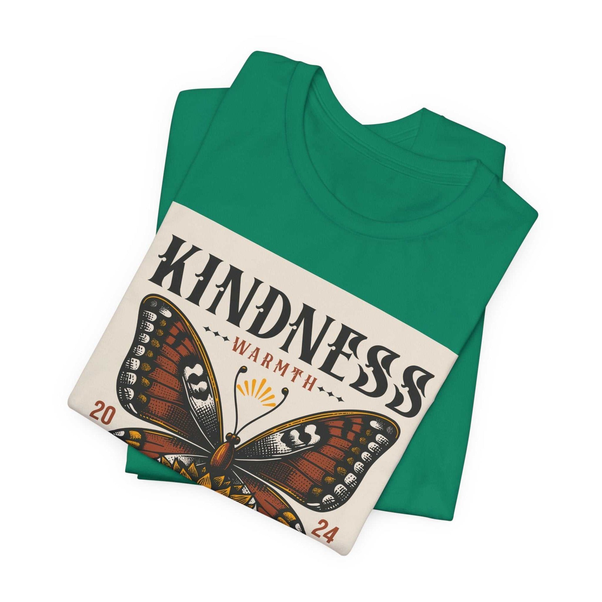 Green Kindness Butterfly Tee with a printed brown butterfly and warmth text folded on white background