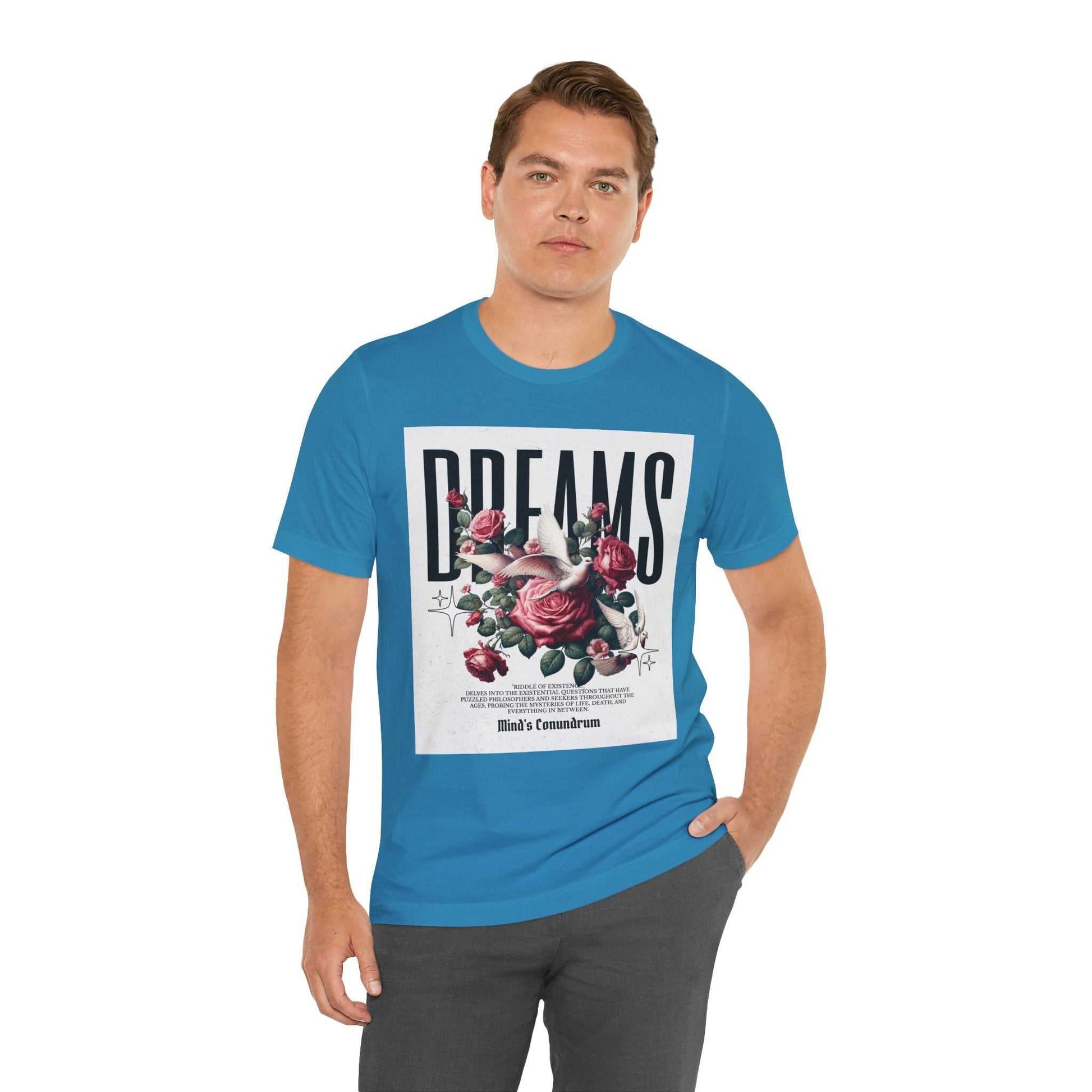 Man wearing blue Dreams Floral Tee with rose graphic and bold typography on front