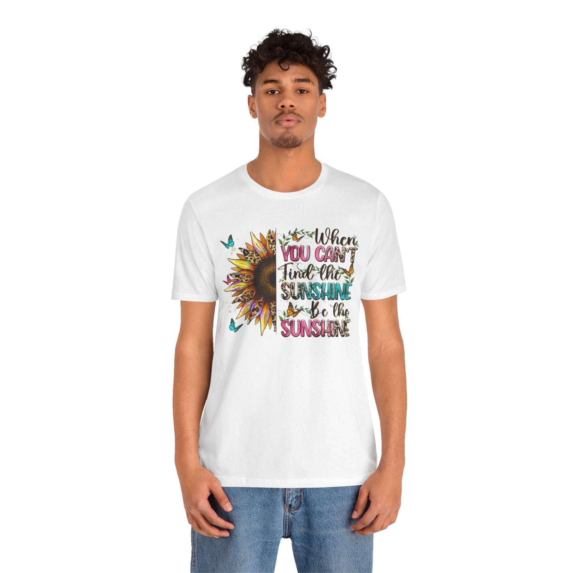 Man wearing white Sunshine Quote Tee with colorful sunflower and motivational text design