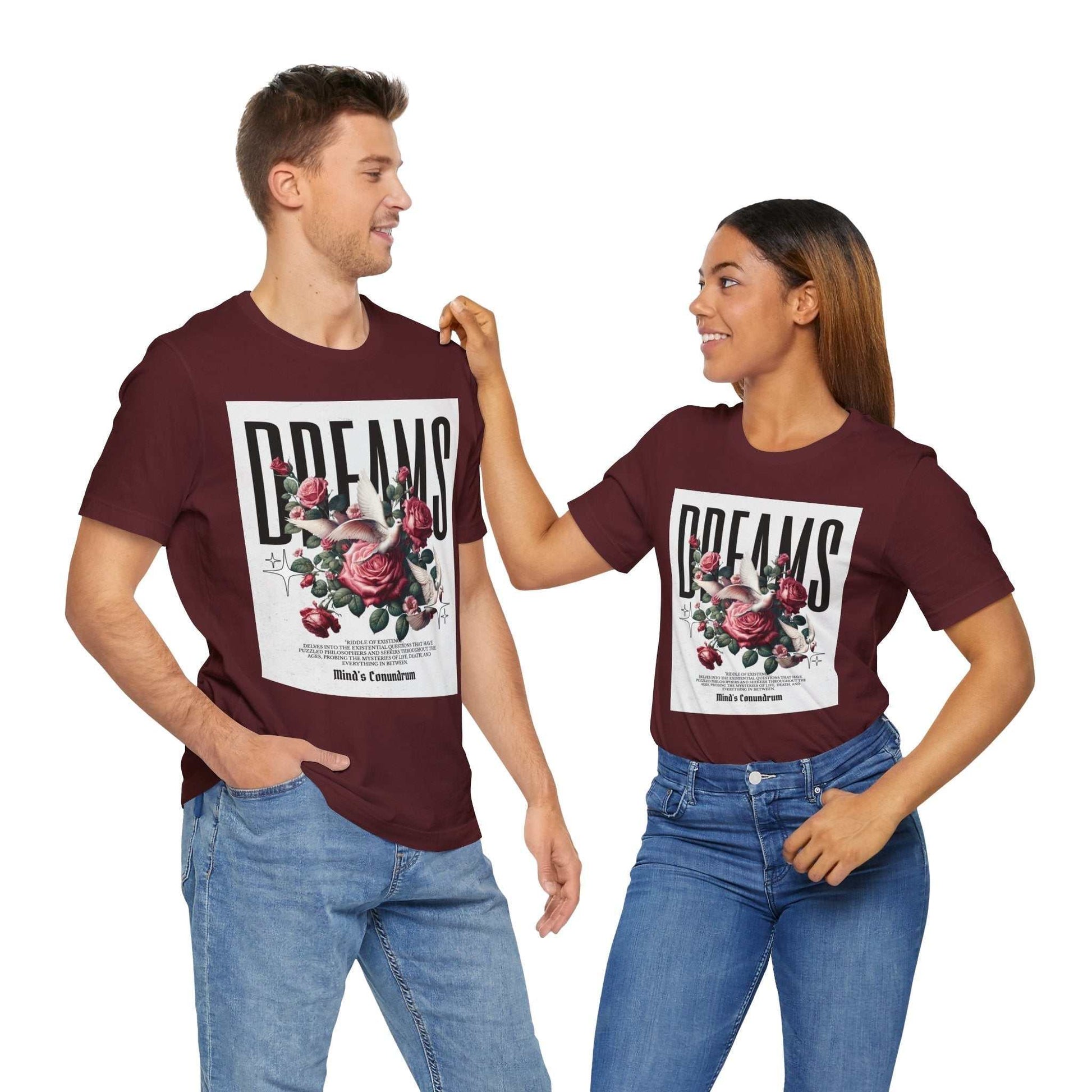 Unisex maroon Dreams Floral Tee with bold typography and large floral graphic, worn by a man and woman in casual jeans.