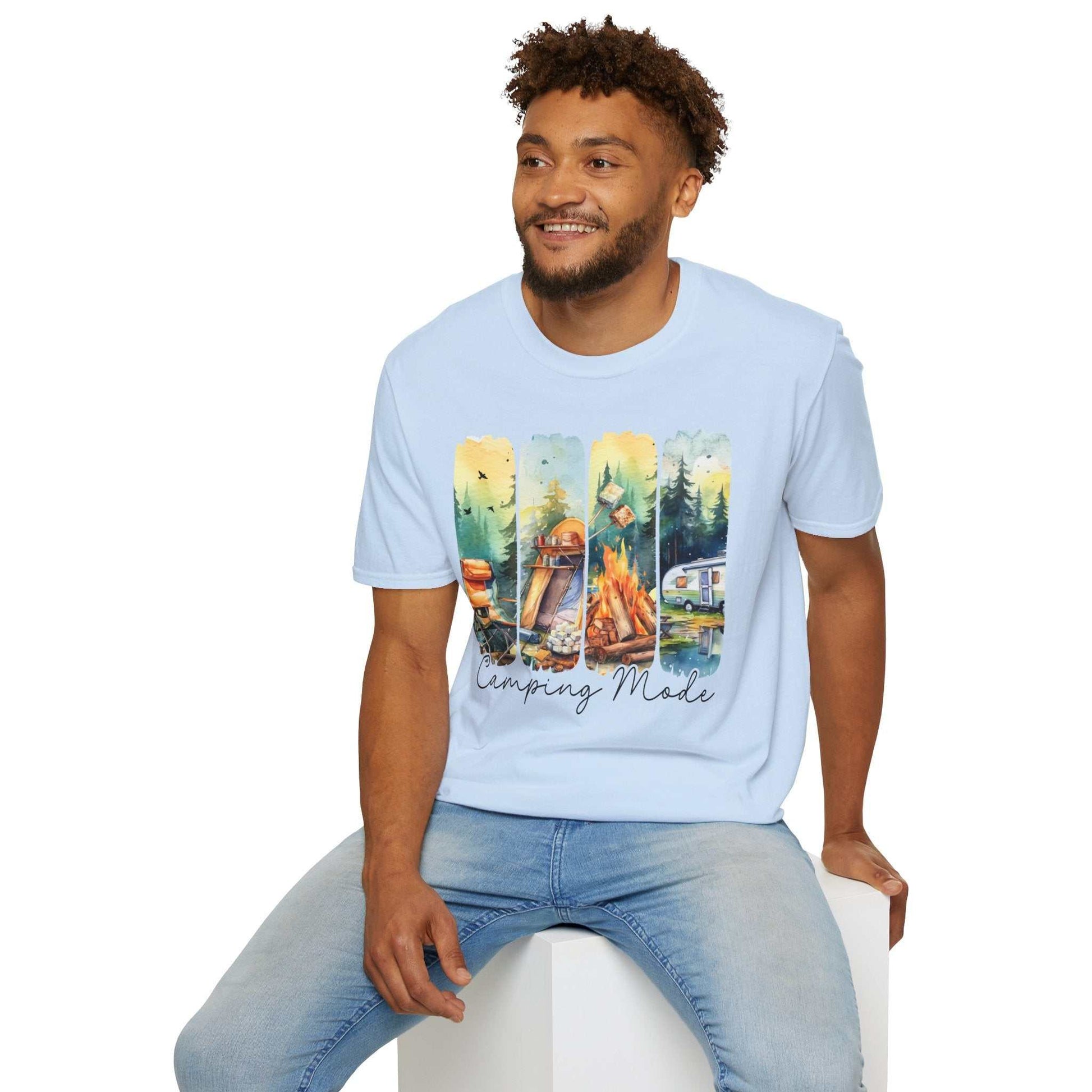Man wearing light blue Camping Adventure Unisex T-Shirt with colorful camping-themed design featuring tent, campfire, and forest scenes.
