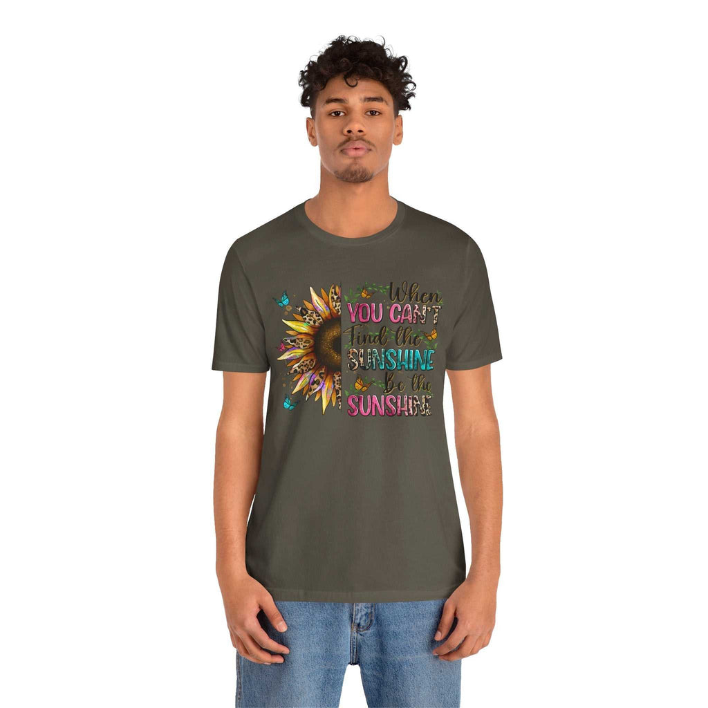Young man wearing olive green Sunshine Quote Tee with vibrant sunflower and motivational text design