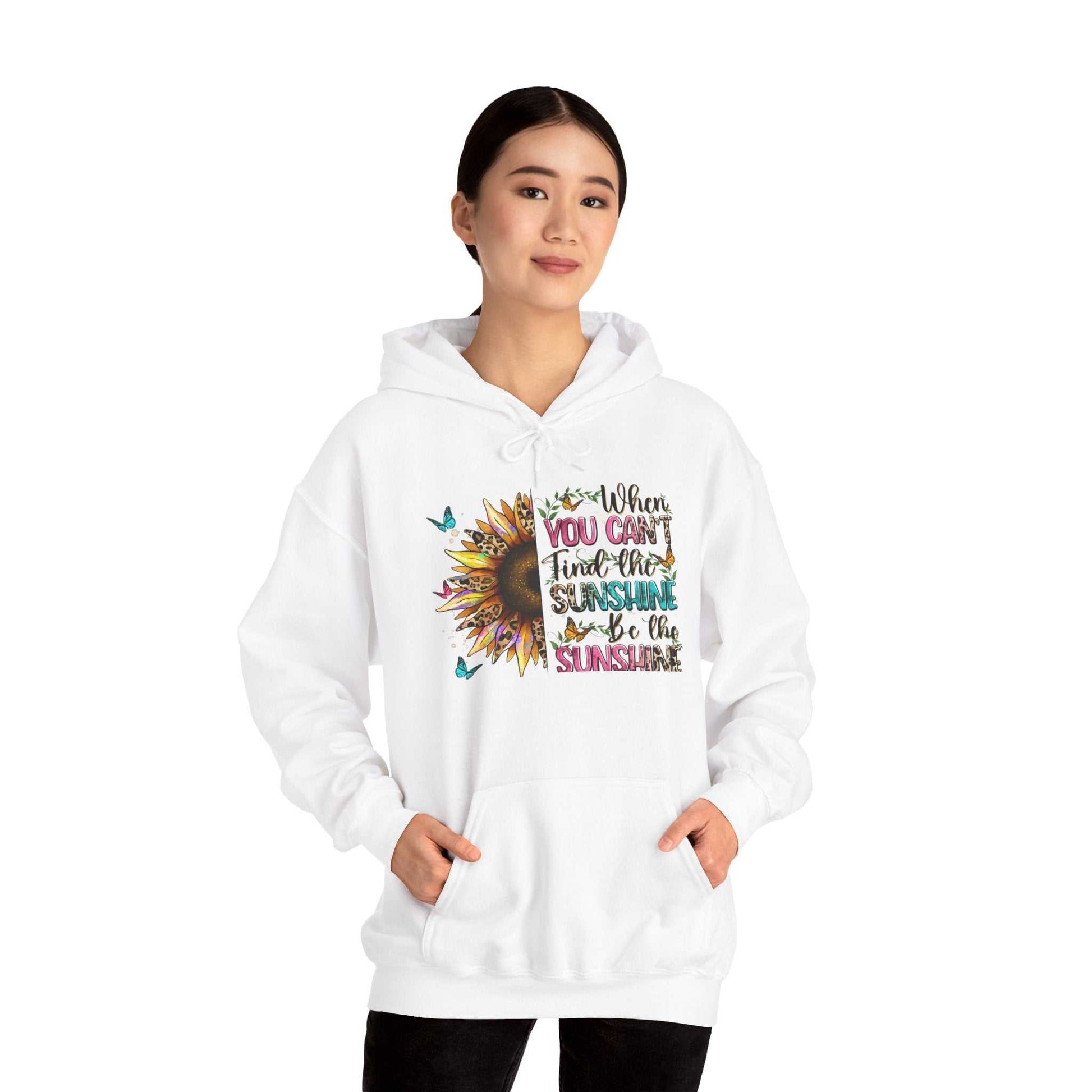 Woman wearing white Sunflower Quote Hoodie with vibrant sunflower and inspirational text design on front