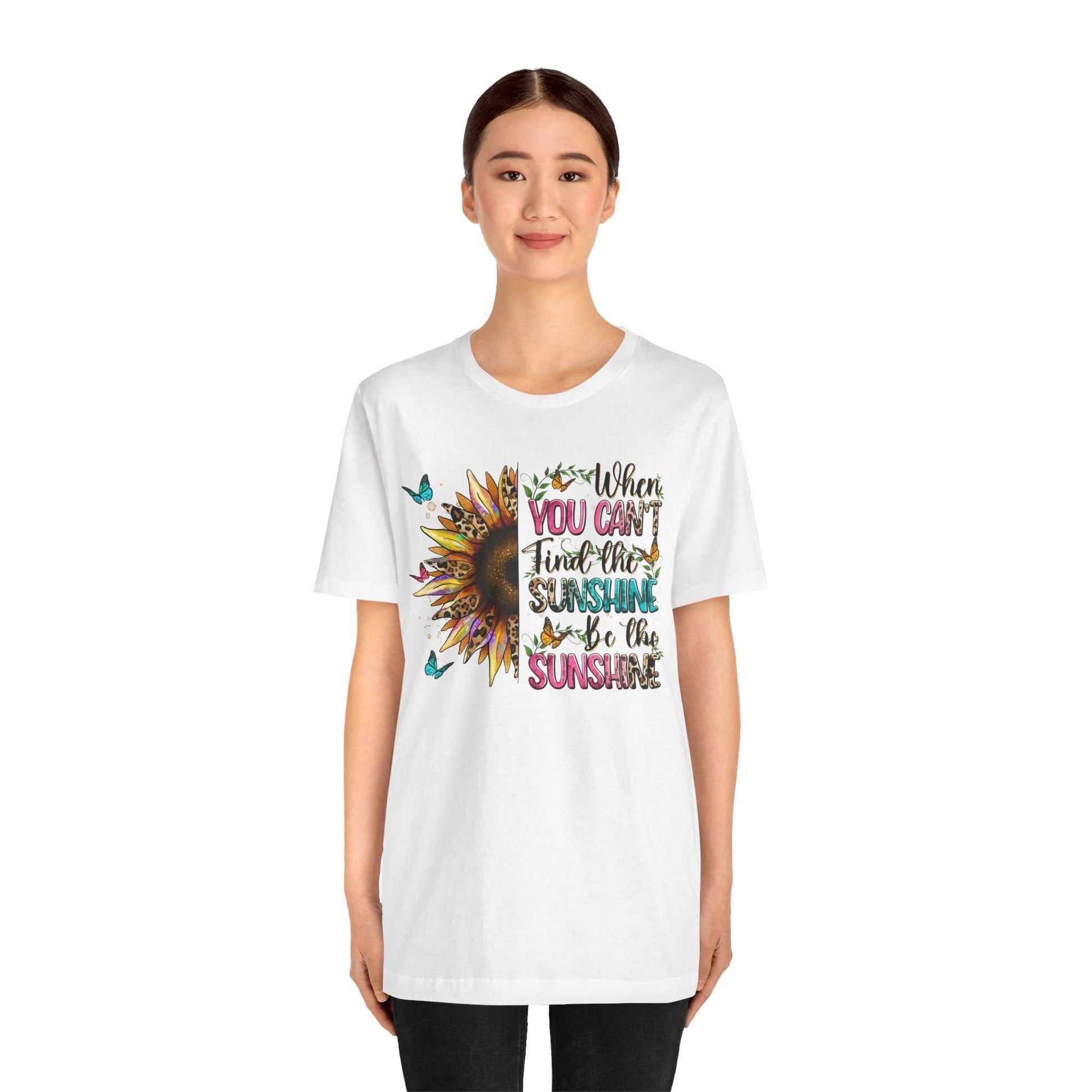 Woman wearing white Sunshine Quote Tee with colorful sunflower and inspirational text design