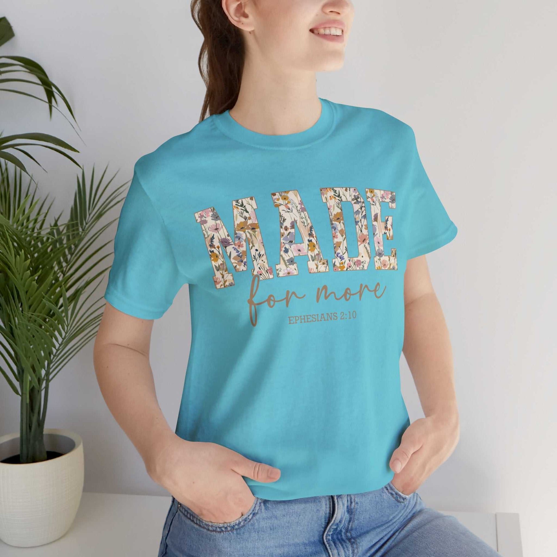 Woman wearing blue Made for More Tee with floral text design, casual fit, and short sleeves