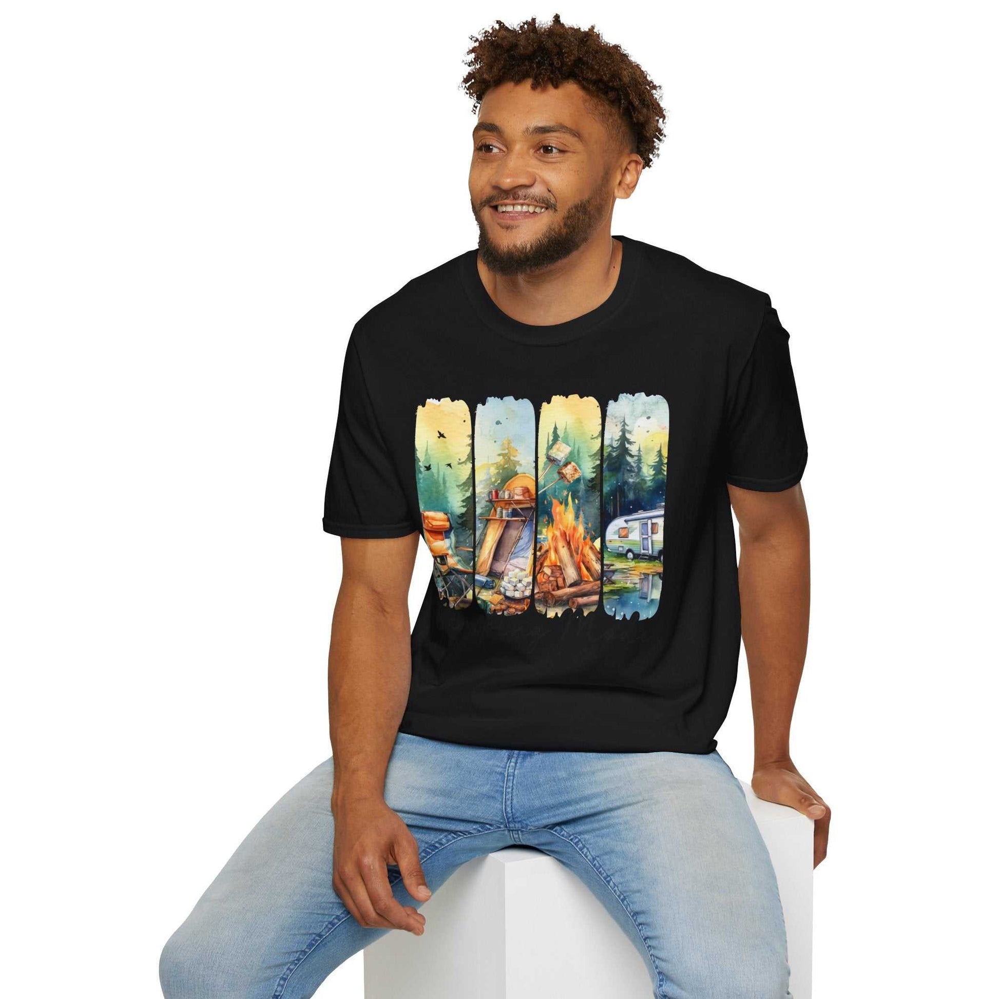 Man wearing black Camping Adventure Unisex T-Shirt with colorful camping scene print sitting on white block