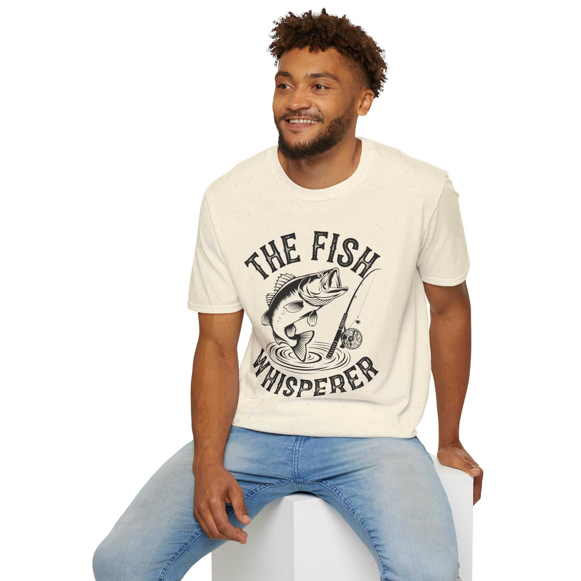 Unisex softstyle t-shirt with "The Fish Whisperer" fishing graphic, made of lightweight 100% cotton.