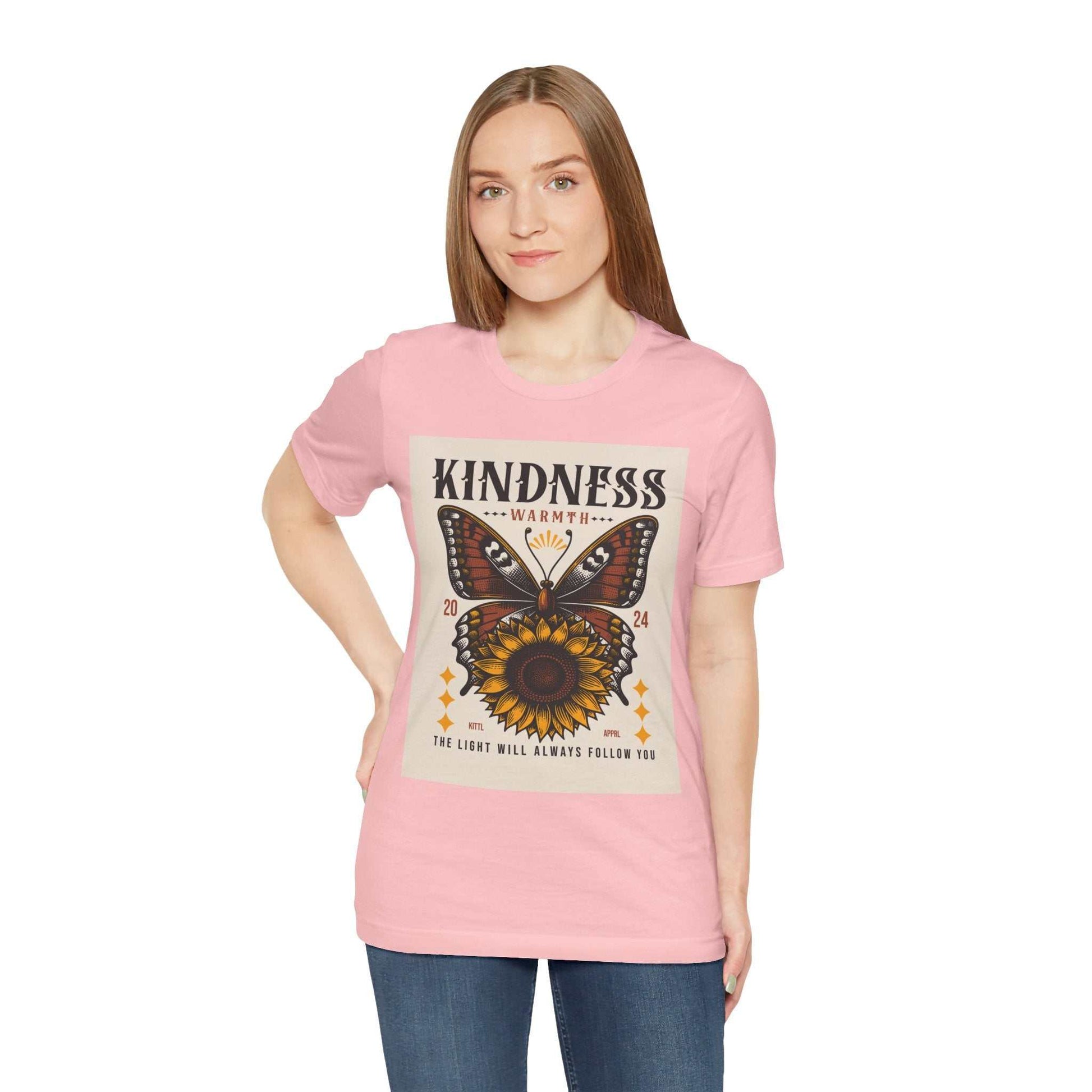 Woman wearing pink Kindness Butterfly Tee with butterfly and sunflower design and positive message on front