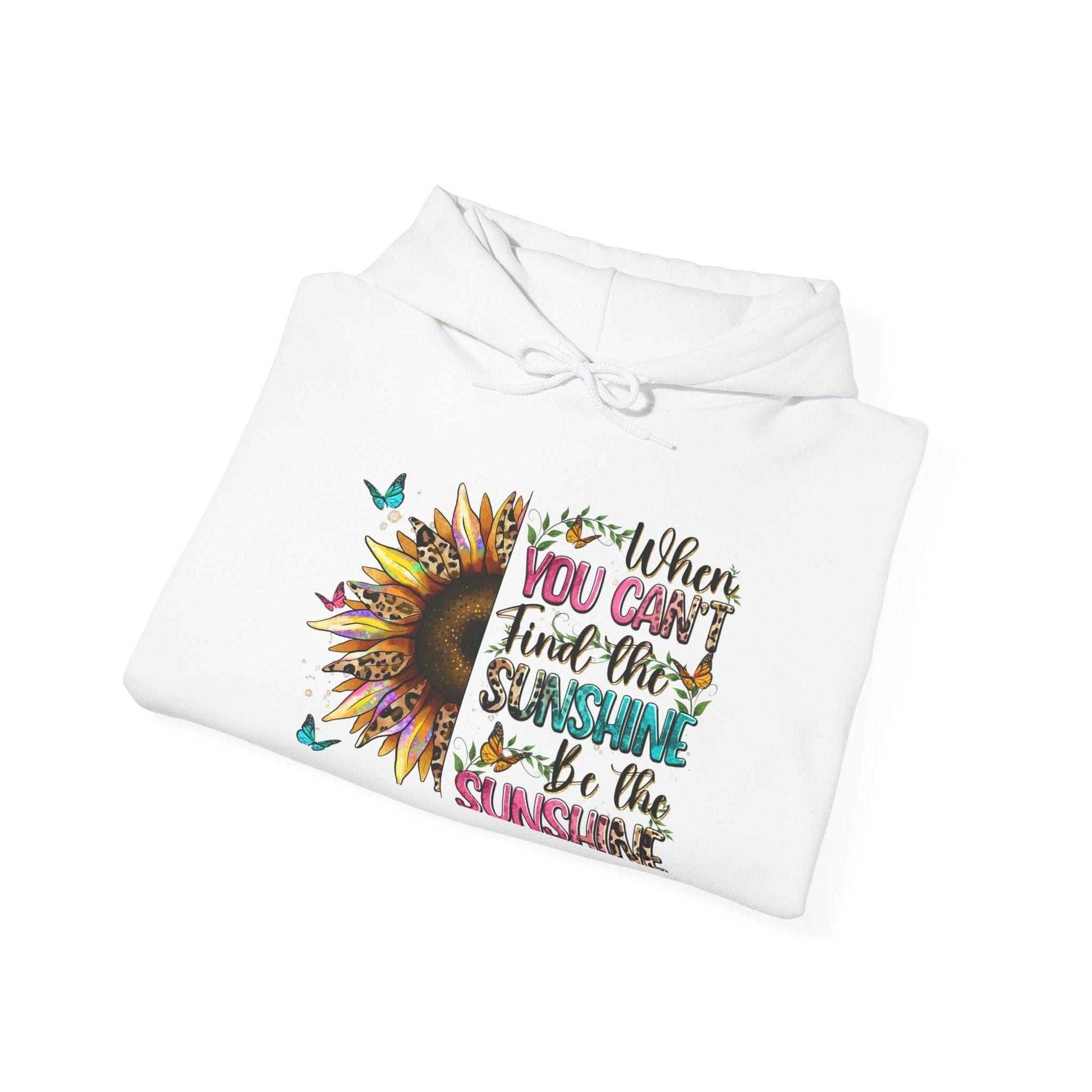 White hoodie with colorful sunflower and inspirational quote design reading "When you can't find the sunshine be the sunshine"