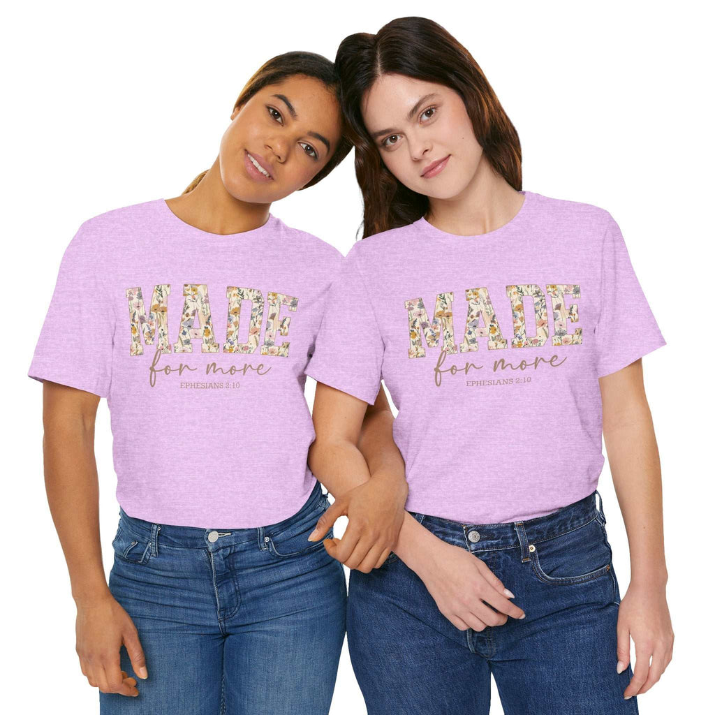Two women wearing light purple Made for More Tee shirts with floral text design on front standing close together