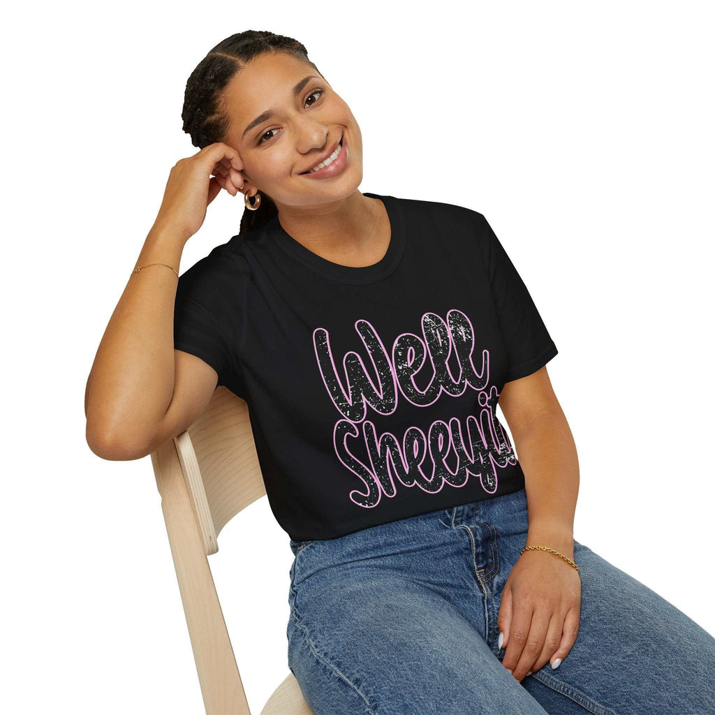 Woman wearing black casual statement tee with "Well Sheeyit" funny quote sitting on wooden chair