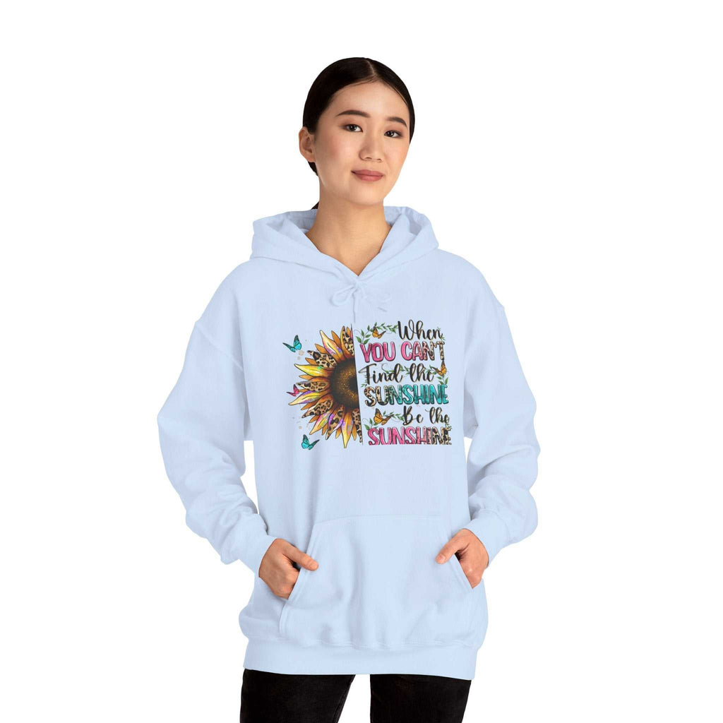 Woman wearing light blue sunflower quote hoodie with inspirational message and kangaroo pocket