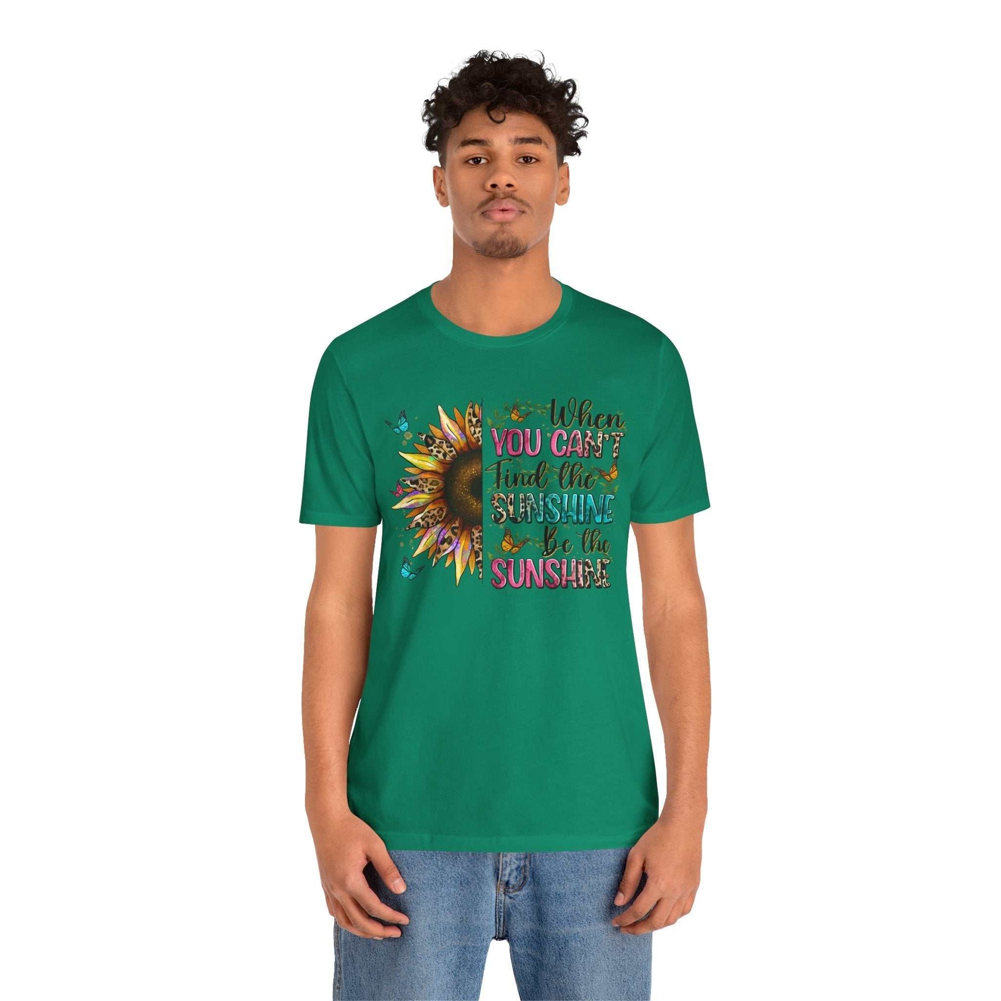 Man wearing green Sunshine Quote Tee with sunflower graphic and inspirational text on front