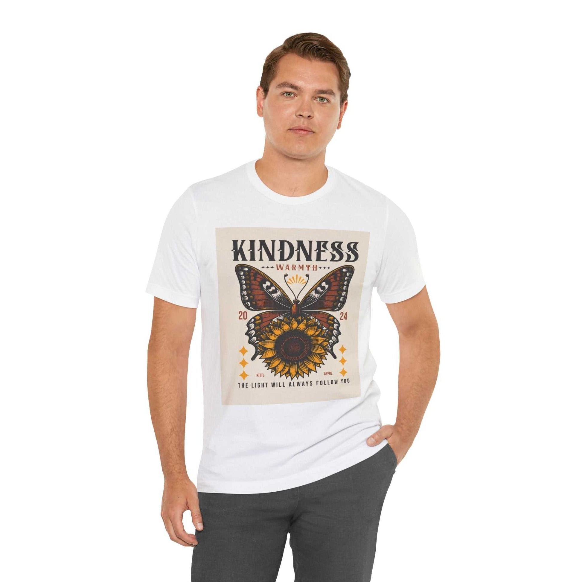 Man wearing white Kindness Butterfly Tee with butterfly and sunflower graphic and text "Kindness Warmth" on front