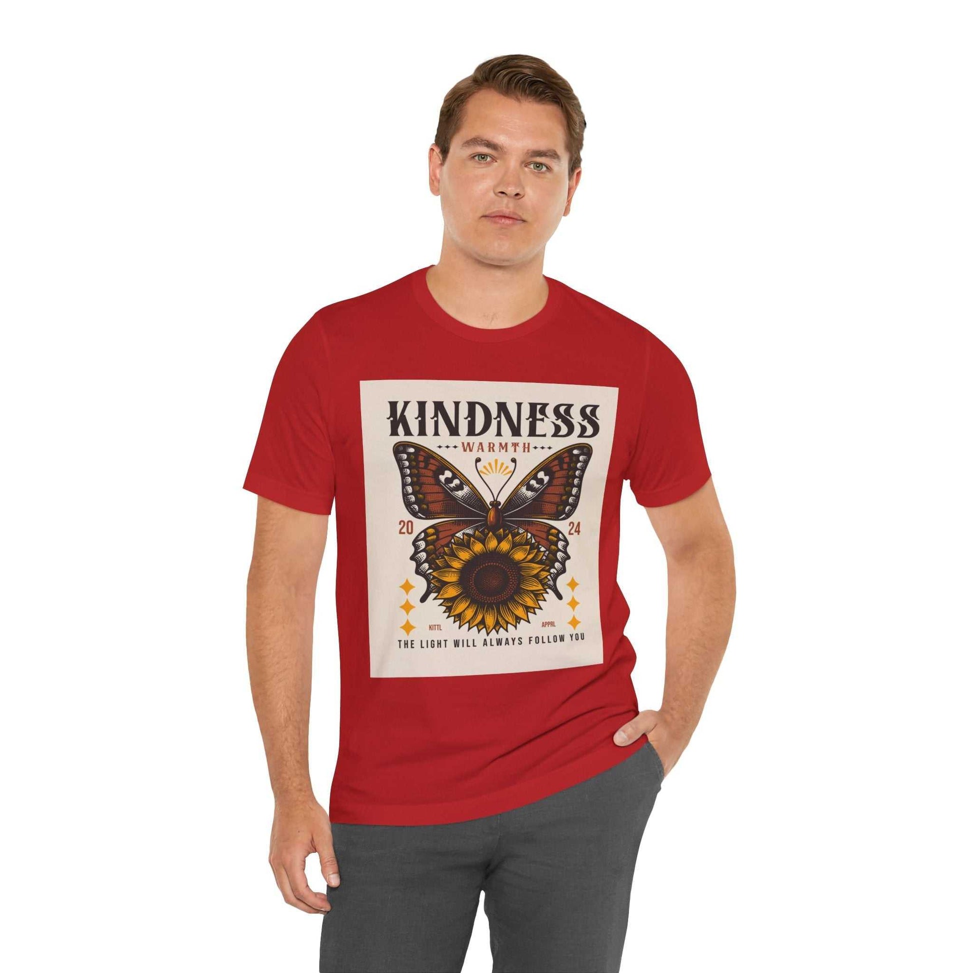 Man wearing red Kindness Butterfly Tee featuring butterfly and sunflower design with "Kindness Warmth" text and inspirational quote.