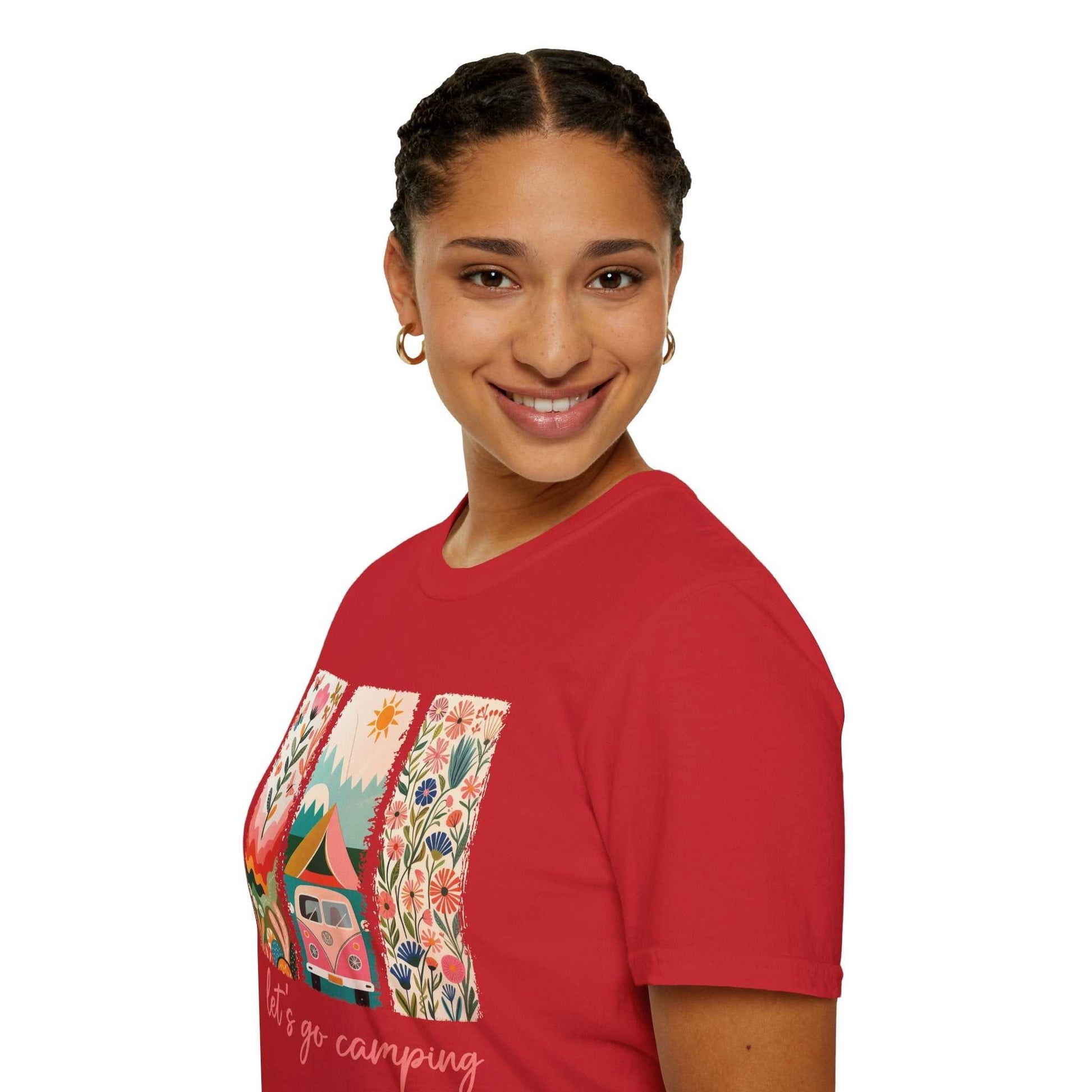 woman wearing red unisex softstyle t-shirt with colorful camping adventure design including van and nature elements