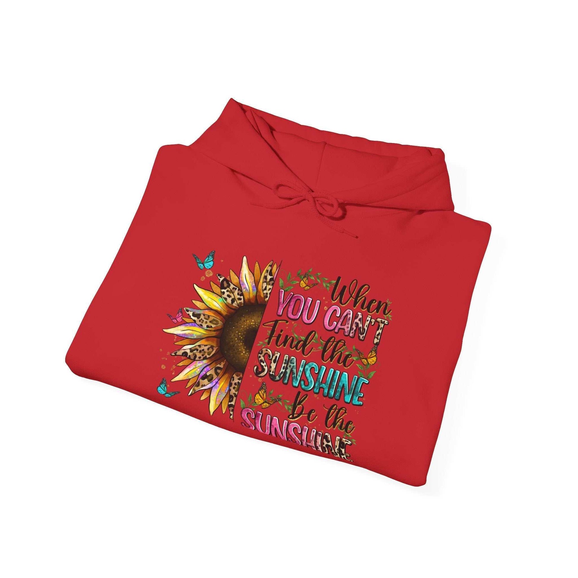 Red sunflower quote hoodie with inspirational text and butterfly accents, folded flat.